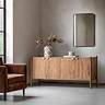 image of acacia wood sideboard with four doors and gold handles, against wall