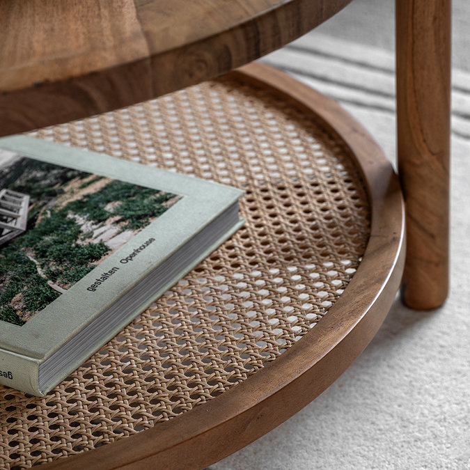 close up image of rattan lower shelf of round acacia wood coffee table