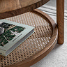 close up image of rattan lower shelf of round acacia wood coffee table