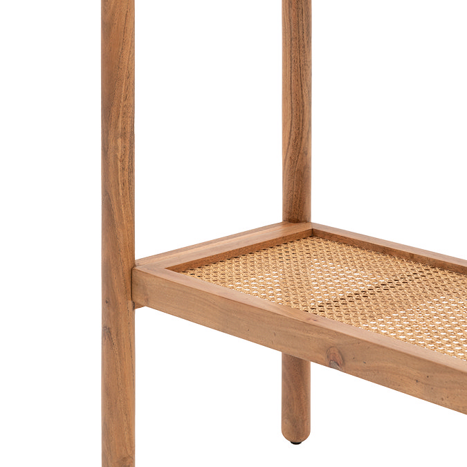 close up image of rattan lower shelf of console table