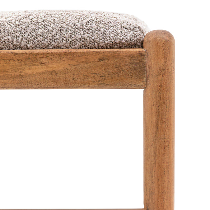 close up image of corner of acacia wood bench with grey boucle seat pad