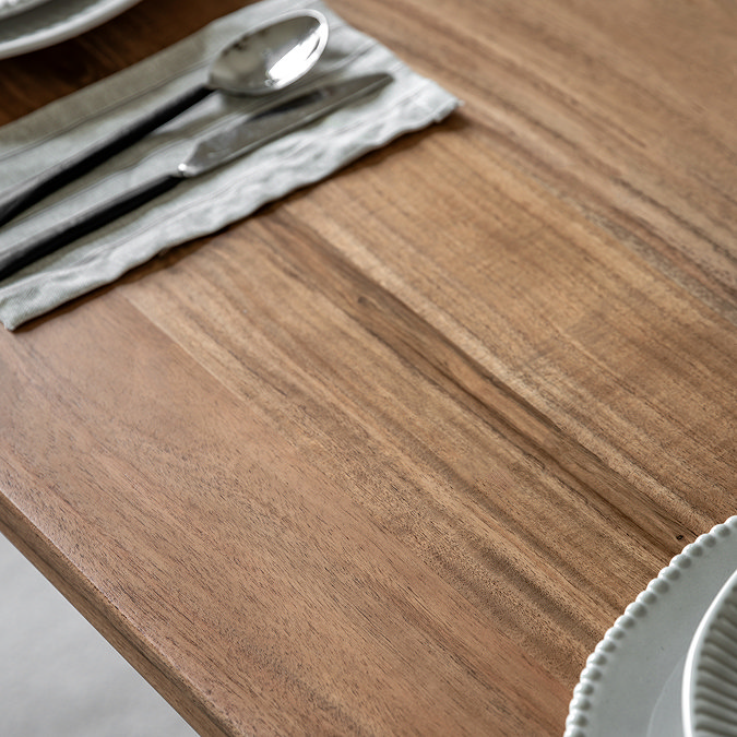 close up image of acacia woodgrain of large dining table