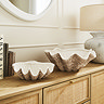 a large and medium shell shaped bowl on shelf
