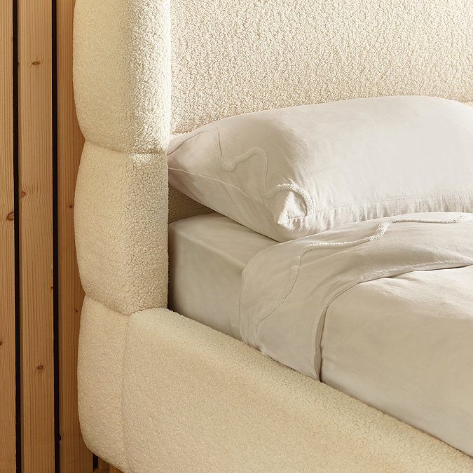 close up image of beige boucle bedframe