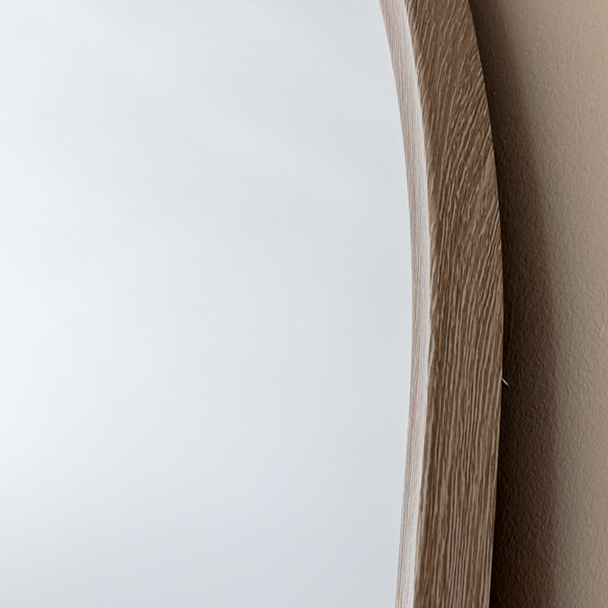 close up image of soft grey frame of arched overmantle mirror