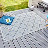 image of rectangular geometric patterned slate grey rug on grey patio
