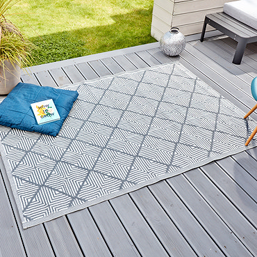 image cut out on white background of grey and white diagonal-lined rug laid out