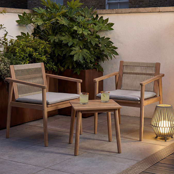 image of classic wooden bistro set on a balcony at dusk