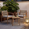 image of classic wooden bistro set on a balcony at dusk