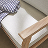 close up image of cream coloured cushion of acacia wood corner sofa