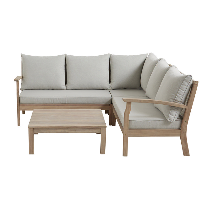 image cut out on white background of cream corner sofa with acacia wood rectangular table