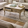 lifestyle image of limed oak french style coffee table with left drawer pulled out