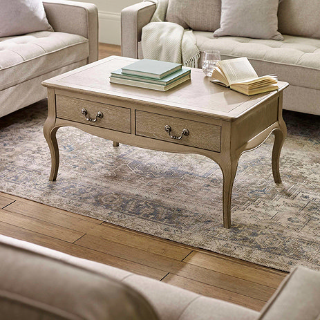 lifestyle image of limed oak french style coffee table with curved legs