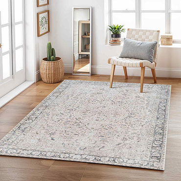 image of grey and blush pink floral rug folded slightly to show its thinness