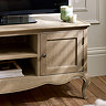 close up image on small cupboard door of french style tv unit