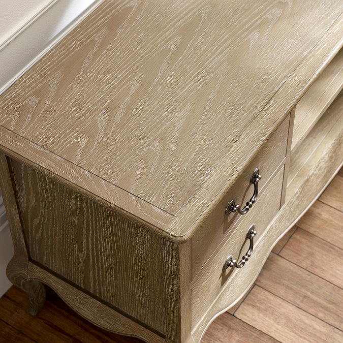 close up image of woodgrain top of french style limed oak tv unit