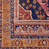 close up swatch image of dark orange, red and navy boho rug 
