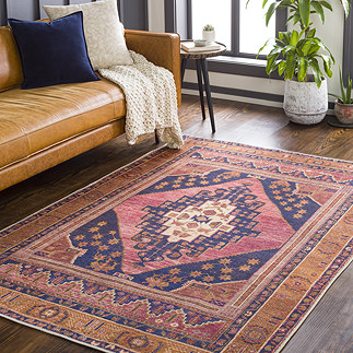 image of dark orange rug with central red and navy boho pattern on apartment floor