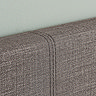 close up zoomed in image of grey fabric of single bed's headboard