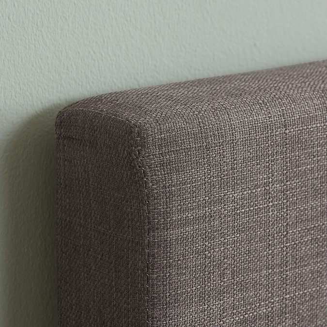 close up image of grey fabric of single bed's headboard