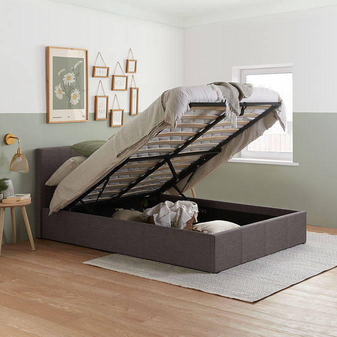 image of grey double ottoman bed with top lifted up to reveal storage space underneath