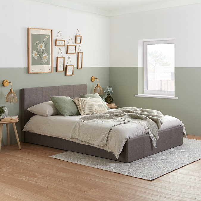 image of double grey fabric ottoman bed in sage green bedroom, with linen and sage bed accessories