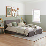 image of double grey fabric ottoman bed in sage green bedroom, with linen and sage bed accessories