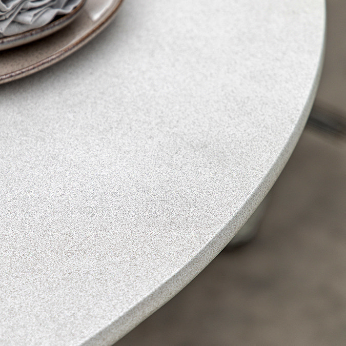 close up image of concrete tabletop of cream garden dining table