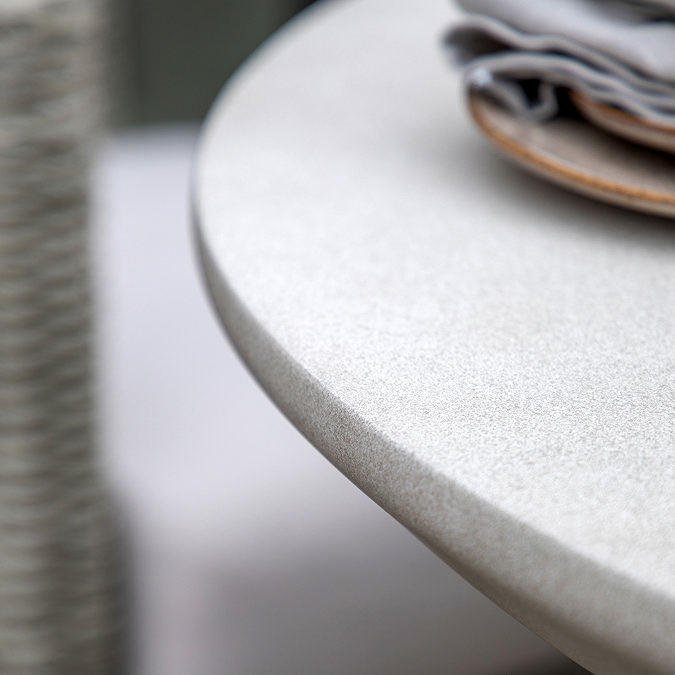 close up image of smooth rounded edge of concrete tabletop in cream colour, with grain effect