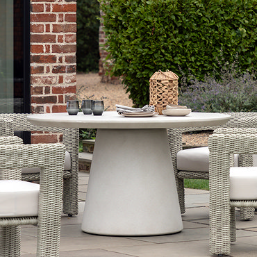 close up image of concrete tabletop of cream garden dining table