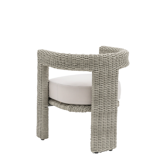 image taken from the back of wicker dining chair with cream plush cushion