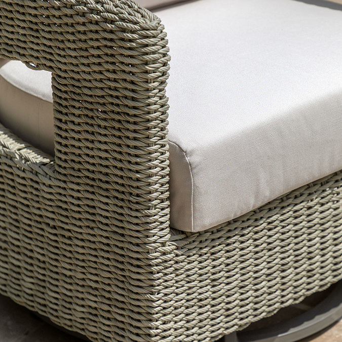close up image of wicker garden chair with plush cream seat cushion