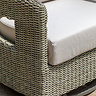 close up image of wicker garden chair with plush cream seat cushion