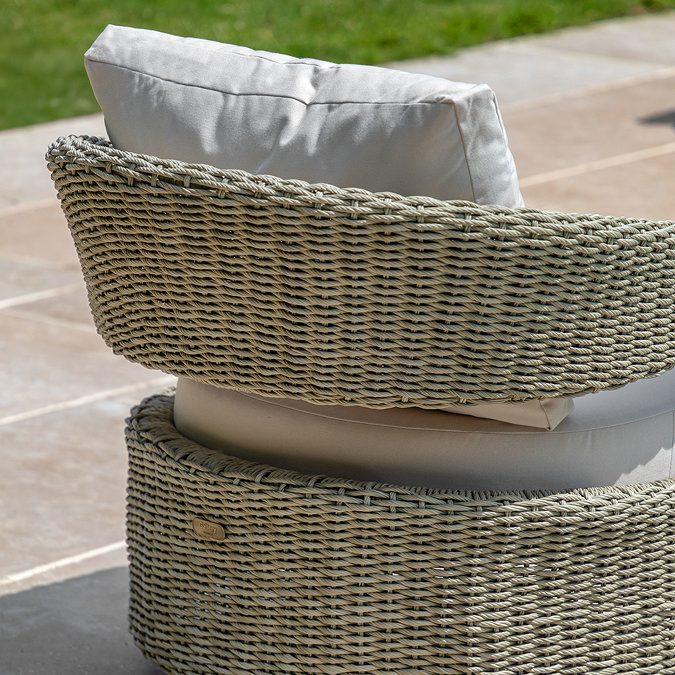 image taken from the back of wicker garden chair with cream cushion