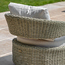 image taken from the back of wicker garden chair with cream cushion