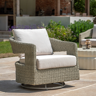 close up image of wicker garden chair with plush cream seat cushion