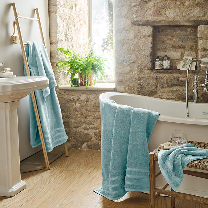 wide shot of ocean blue coloured towels draped around bathroom