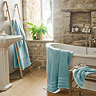 wide shot of ocean blue coloured towels draped around bathroom