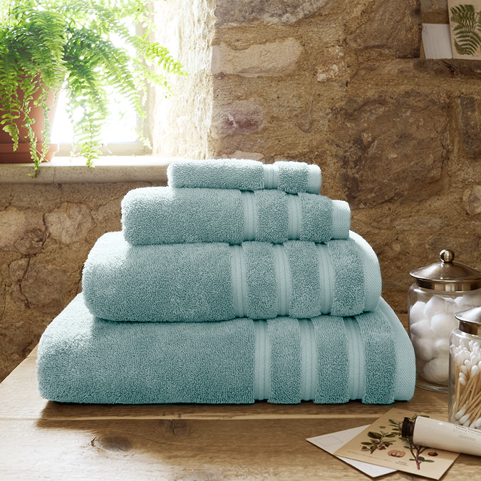 Ocean blue towel stack in bathroom image 1