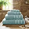 Ocean blue towel stack in bathroom image 1