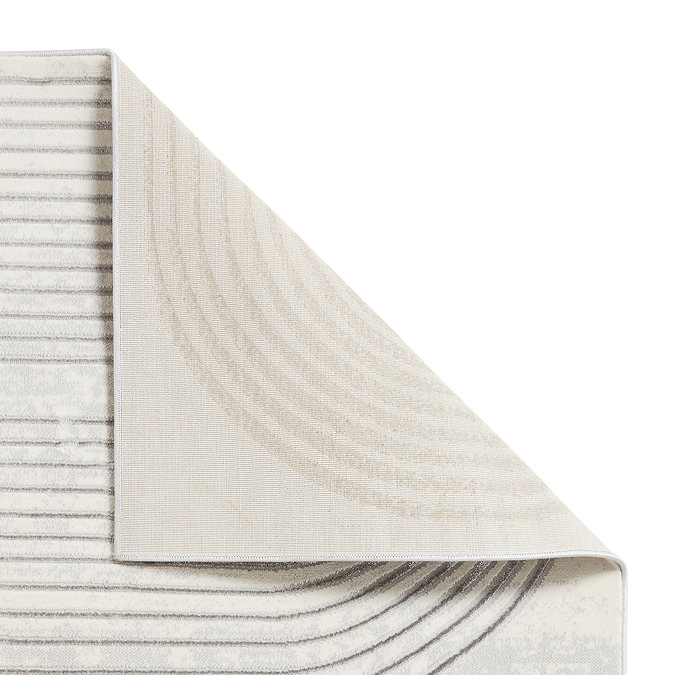 image cut out on white background of grey rug, corner folded over to reveal floor-facing material