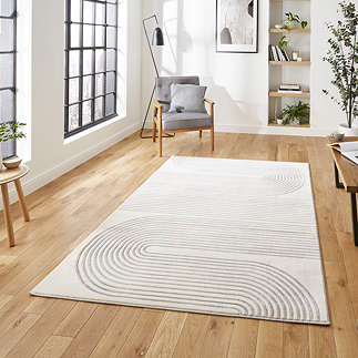 image of large rectangular rug with ivory geometric detailing on wooden floor of modern loft apartment