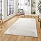 image of large rectangular rug with ivory geometric detailing on wooden floor of modern loft apartment