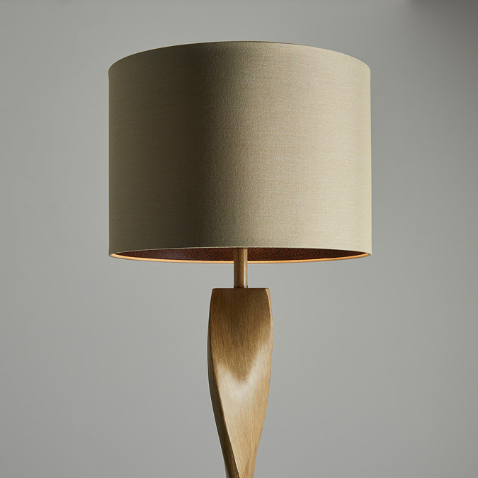 close up on top part of tall floor lamp, focusing on natural coloured linen shade