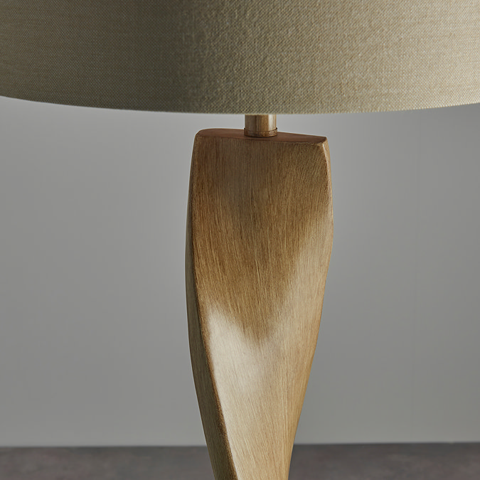 close up on wooden body part of arbor twist lamp, highlighting smooth curve