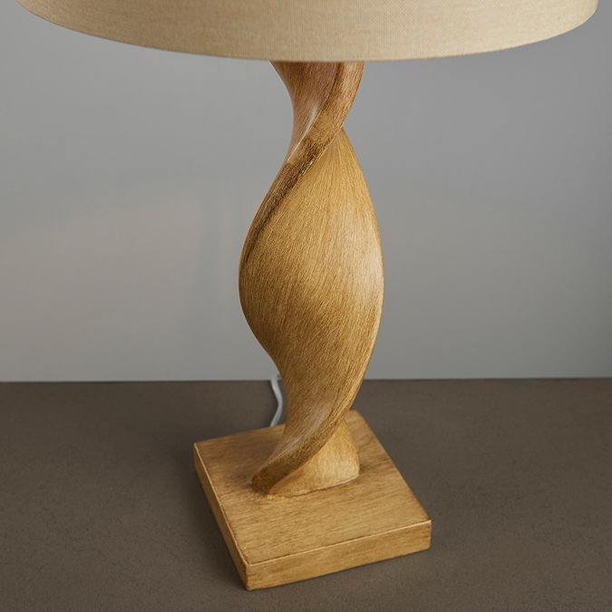 close up on the bottom of the lamp to show twisted wooden base