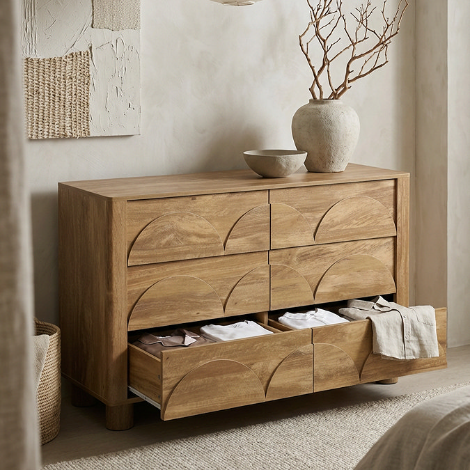 side on image of six drawer mango wood effect chest with bottom drawers open to store clothes