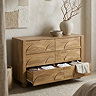 side on image of six drawer mango wood effect chest with bottom drawers open to store clothes