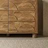 close up image of mango wood effect 6 drawer chest