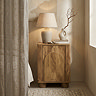 image of bedside table in mango wood effect with gentle arch design on the front, in bedroom